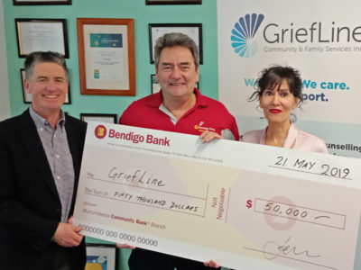 Chris Shaw and Dennis Tarrant from Murrumbeena Community Bank Branch presenting Kaya Latage with a $50,000 donation to GriefLine