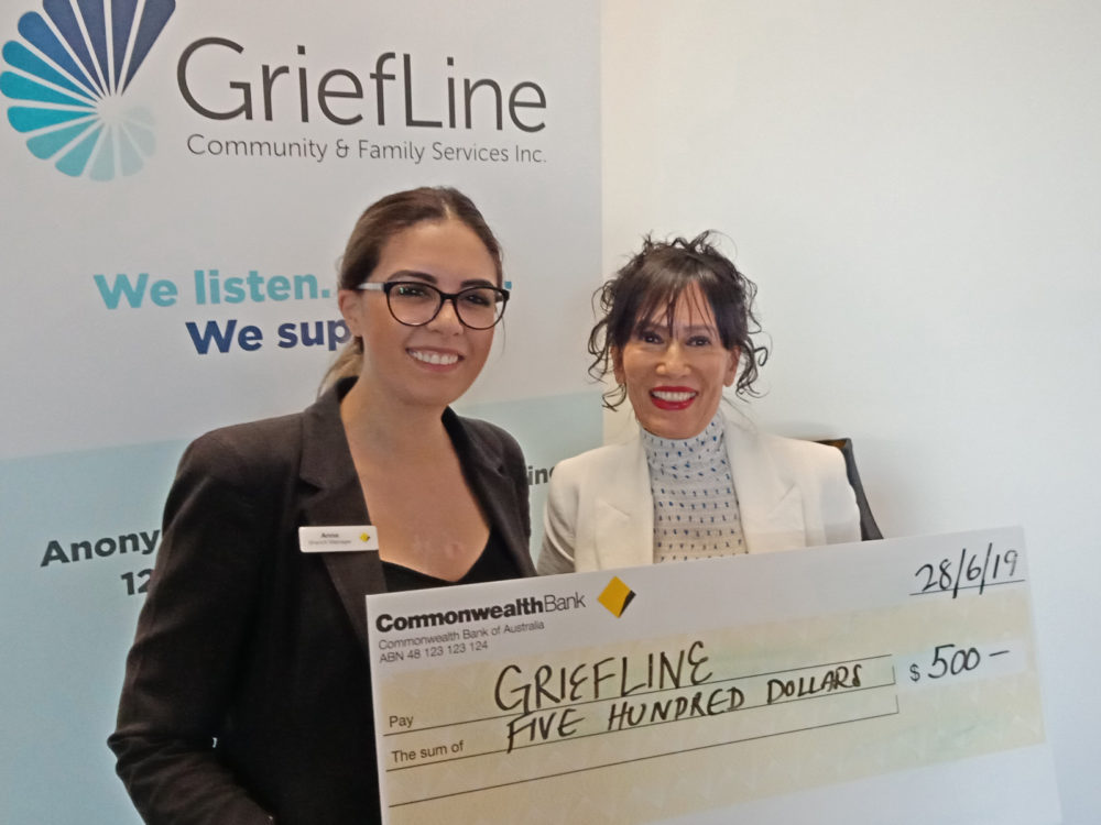 Kaya receives a cheque from Commonwealth Bank's Anna Tschurtz